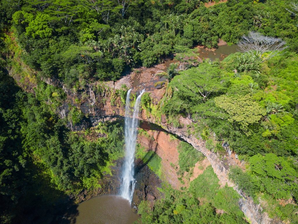 Aerial view on Chamarel waterfall, Mauritius island. Beautiful view of green tropical forest with high waterfall.